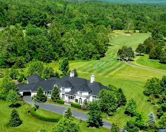 an aerial view of a house with yard swimming pool and outdoor seating