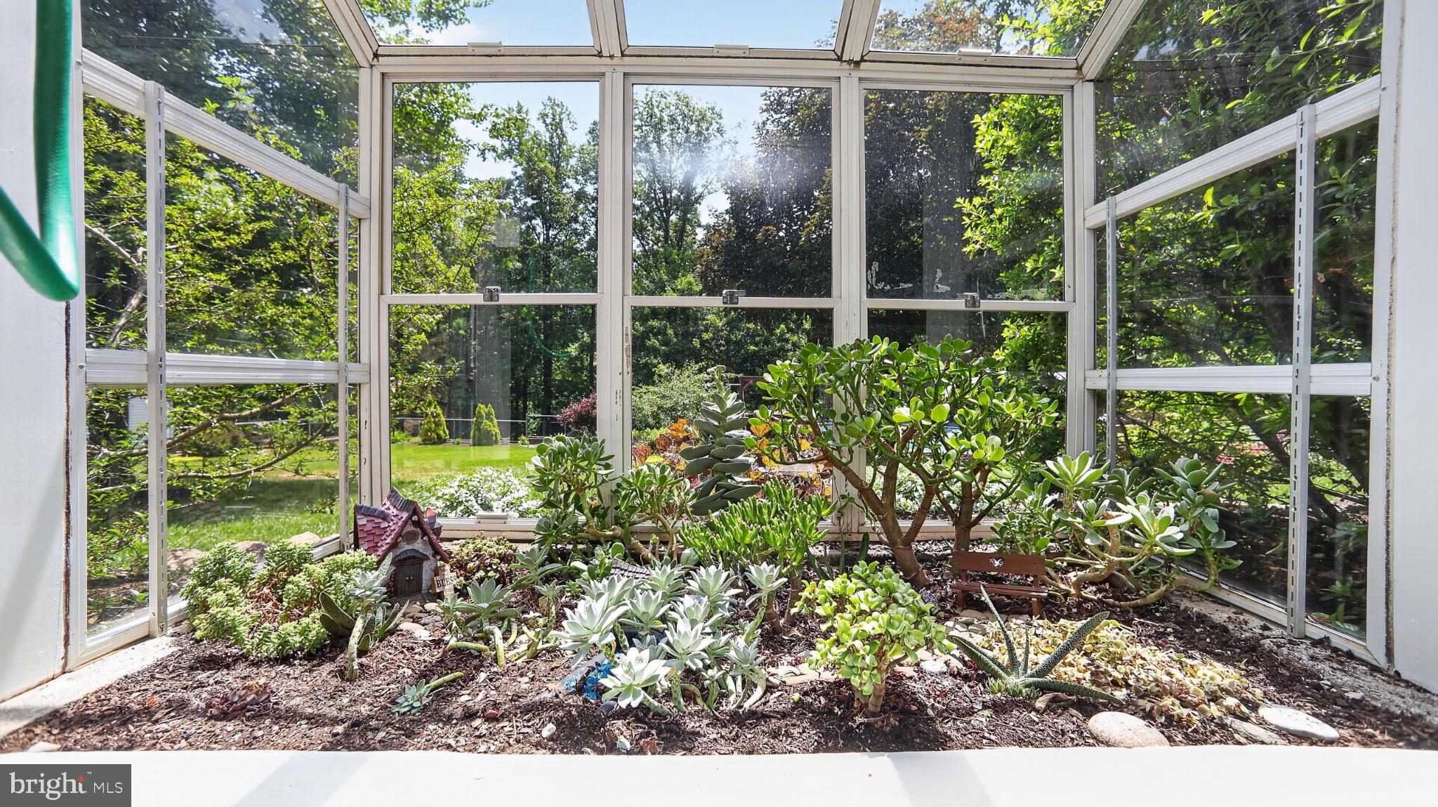 257 Hill Road New Holland, PA 17557 - Photo 74 of 94 Serene greenhouse oasis in bloom.
