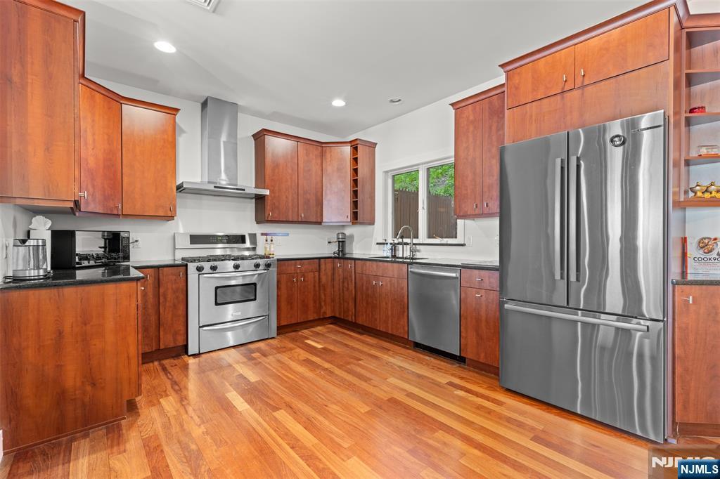 7 Oakdene Terrace, Unit 7 Edgewater, NJ 07020 - Photo 16 of 30 a kitchen with stainless steel appliances granite countertop a refrigerator a sink dishwasher a stove top oven a refrigerator and cabinets