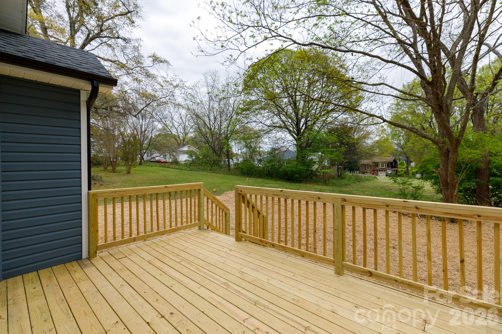 107 Brown Street, Unit 12 Clover, SC 29710 - Photo 16 of 33 a view of deck with wooden floor and fence and a large tree