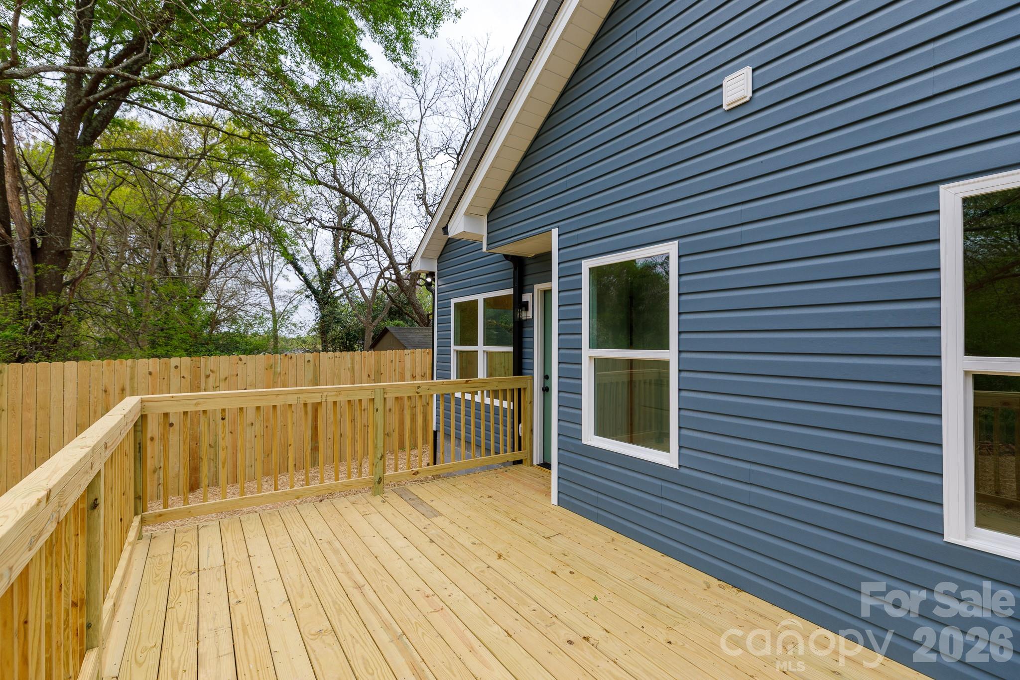 107 Brown Street, Unit 12 Clover, SC 29710 - Photo 17 of 33 a view of a balcony with wooden floor and large trees