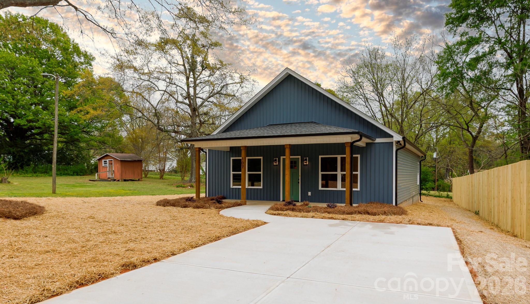 107 Brown Street, Unit 12 Clover, SC 29710 - Photo 2 of 33 a front view of a house with a yard and potted plants