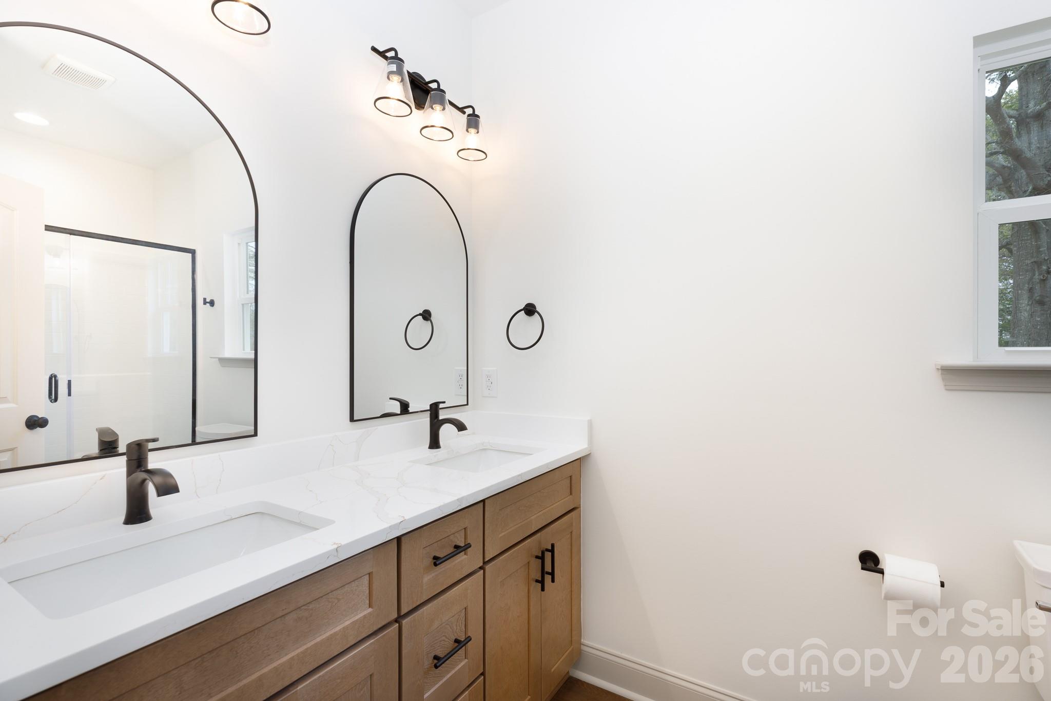107 Brown Street, Unit 12 Clover, SC 29710 - Photo 24 of 33 a bathroom with a double vanity sink and a mirror