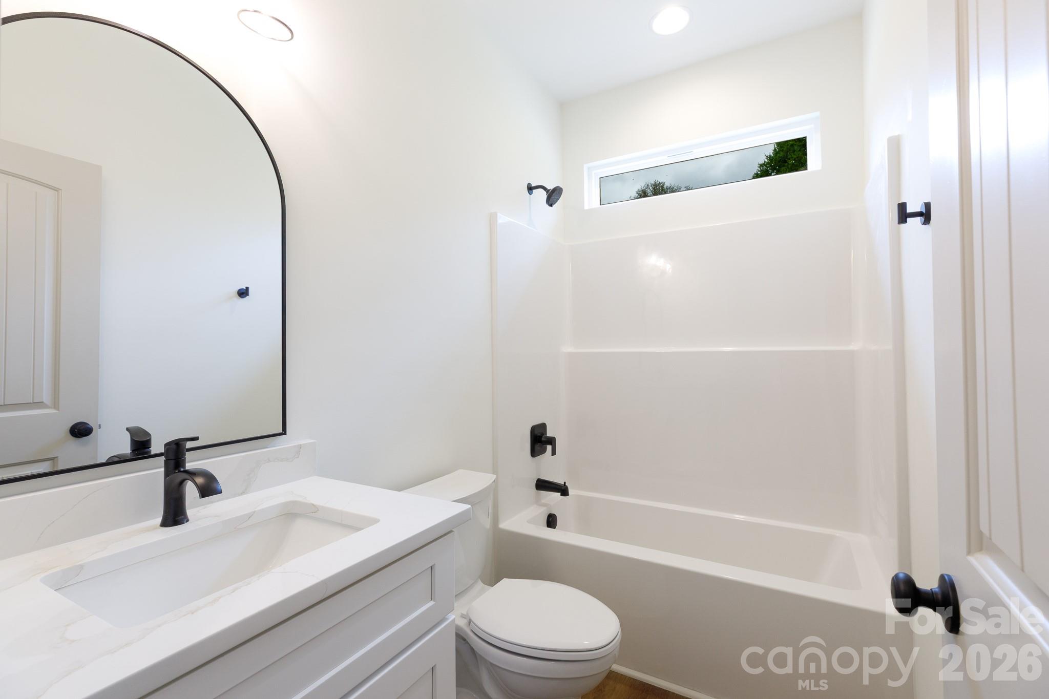 107 Brown Street, Unit 12 Clover, SC 29710 - Photo 27 of 33 a bathroom with a sink a toilet and a mirror