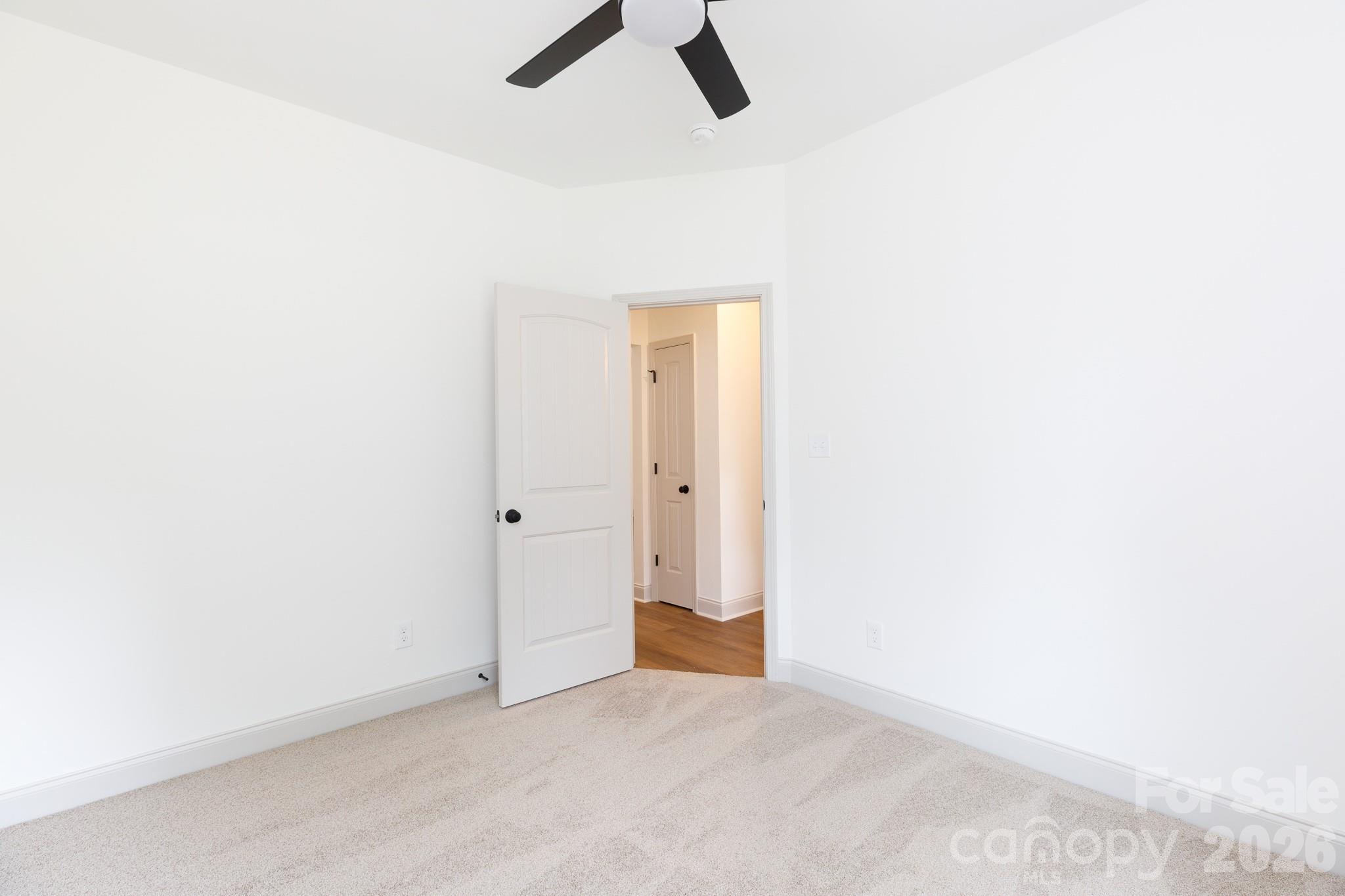 107 Brown Street, Unit 12 Clover, SC 29710 - Photo 29 of 33 an empty room with ceiling fan and window