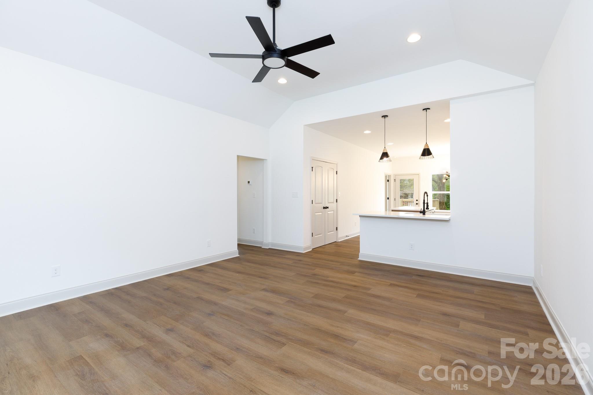 107 Brown Street, Unit 12 Clover, SC 29710 - Photo 7 of 33 a view of empty room with wooden floor and ceiling fan