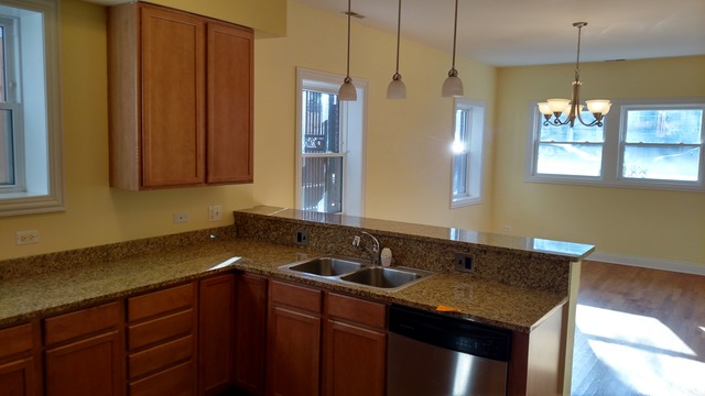 1542 West Sherwin Avenue, Unit GS Chicago, IL 60626 - Photo 3 of 11 a bathroom with a granite countertop sink and a mirror