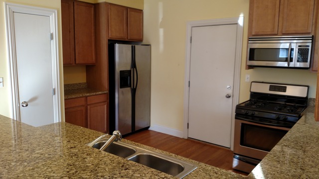 1542 West Sherwin Avenue, Unit GS Chicago, IL 60626 - Photo 4 of 11 a kitchen with a refrigerator and a stove top oven