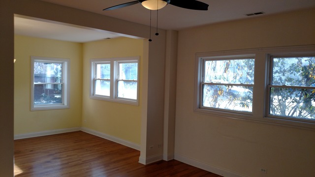 1542 West Sherwin Avenue, Unit GS Chicago, IL 60626 - Photo 6 of 11 a view of an empty room with a window and wooden floor