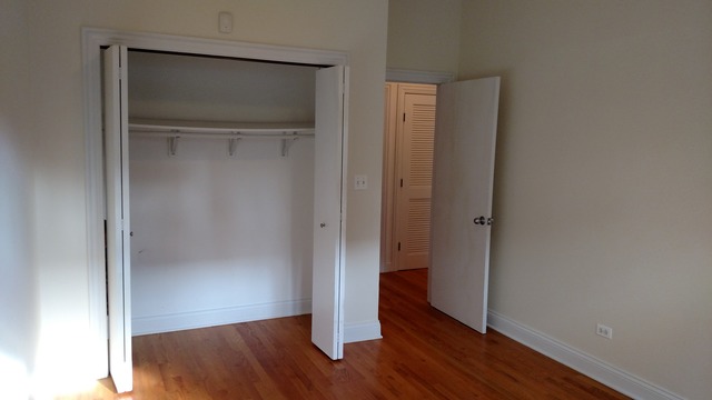 1542 West Sherwin Avenue, Unit GS Chicago, IL 60626 - Photo 7 of 11 a view of an empty room with wooden floor