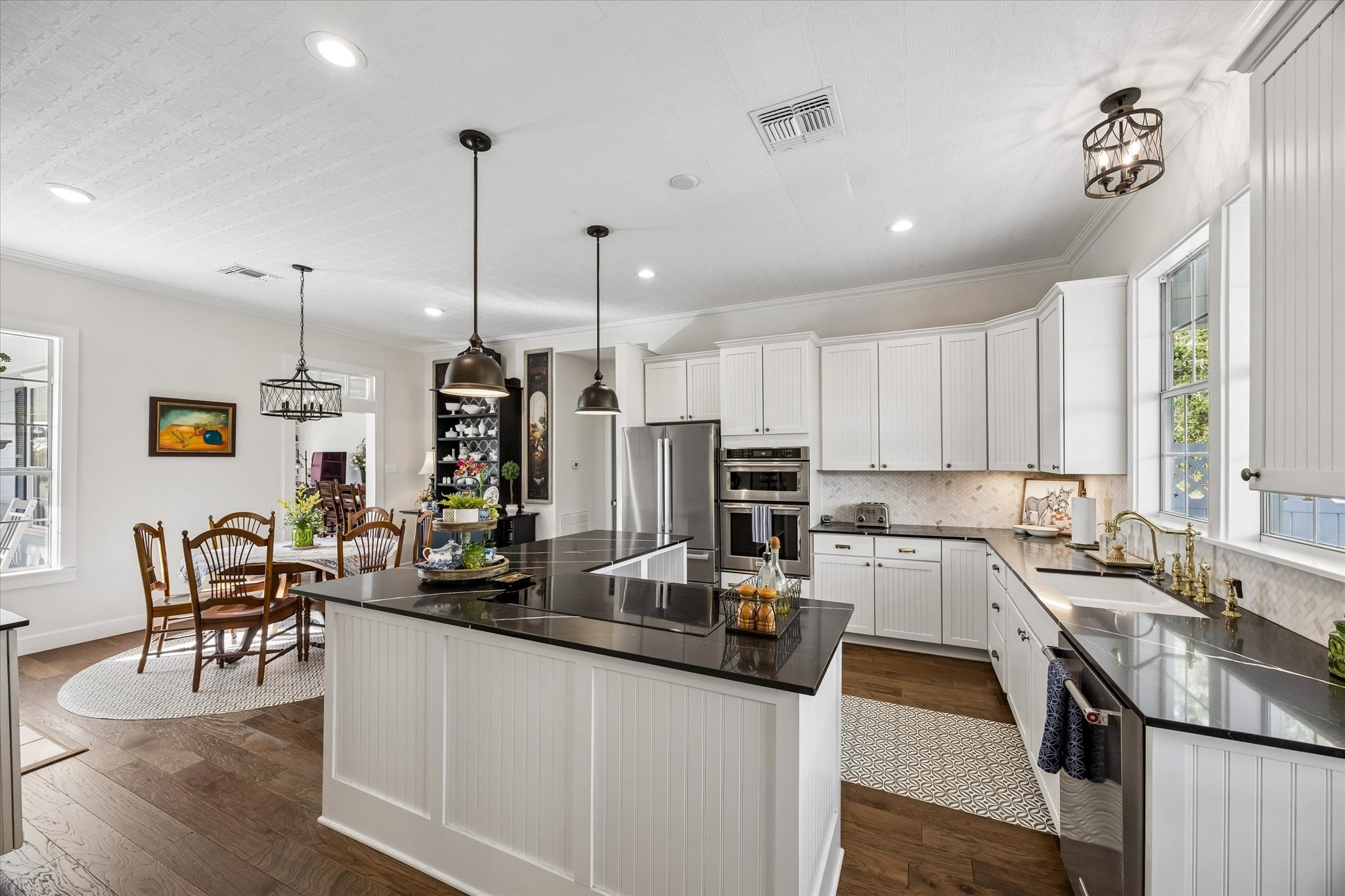 10222 Old Stagecoach Road Chappell Hill, TX 77426 - Photo 13 of 42 a kitchen with stainless steel appliances a table chairs sink refrigerator and microwave