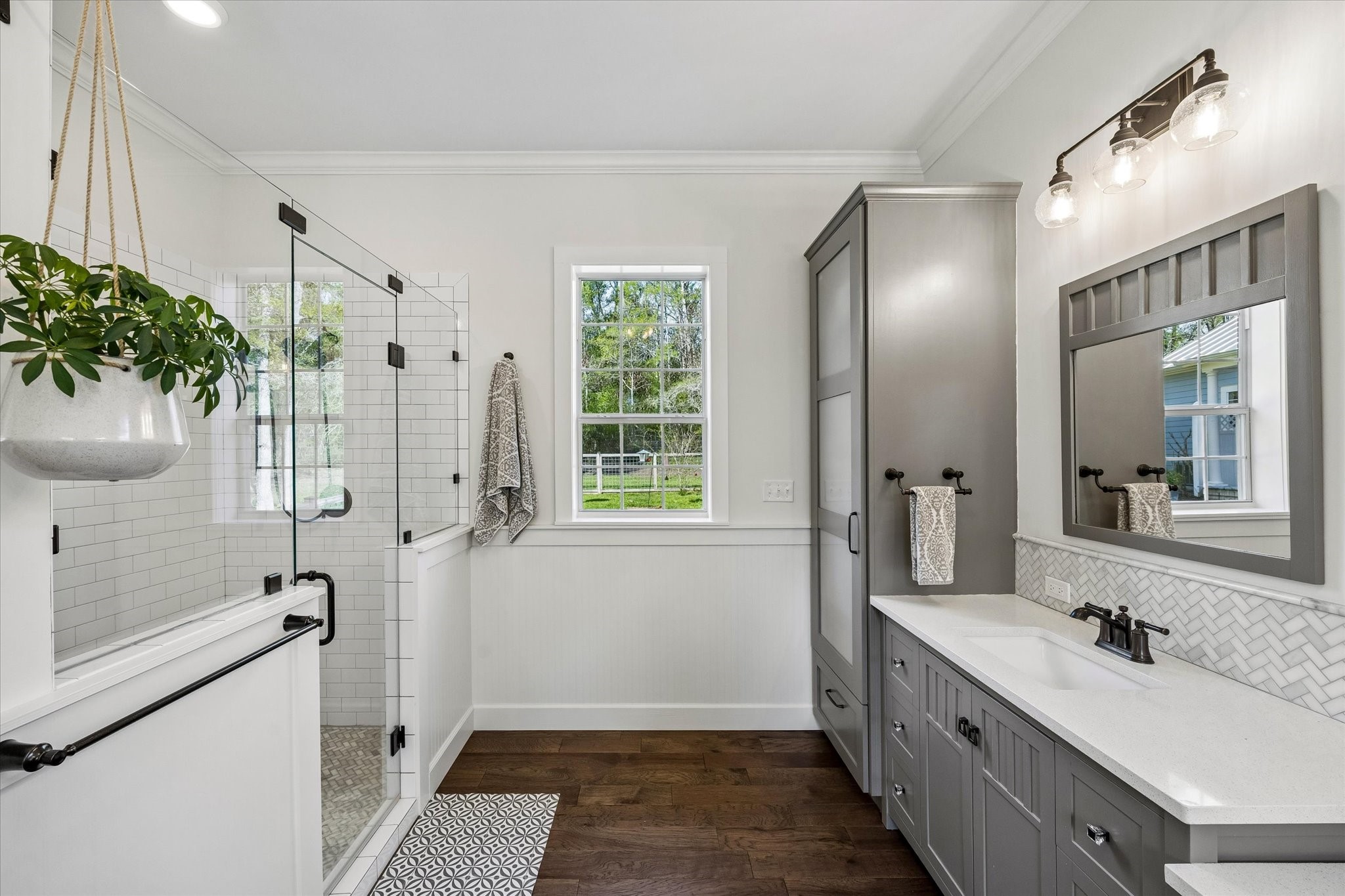 10222 Old Stagecoach Road Chappell Hill, TX 77426 - Photo 19 of 42 a bathroom with a double vanity sink a large mirror a bathtub and shower