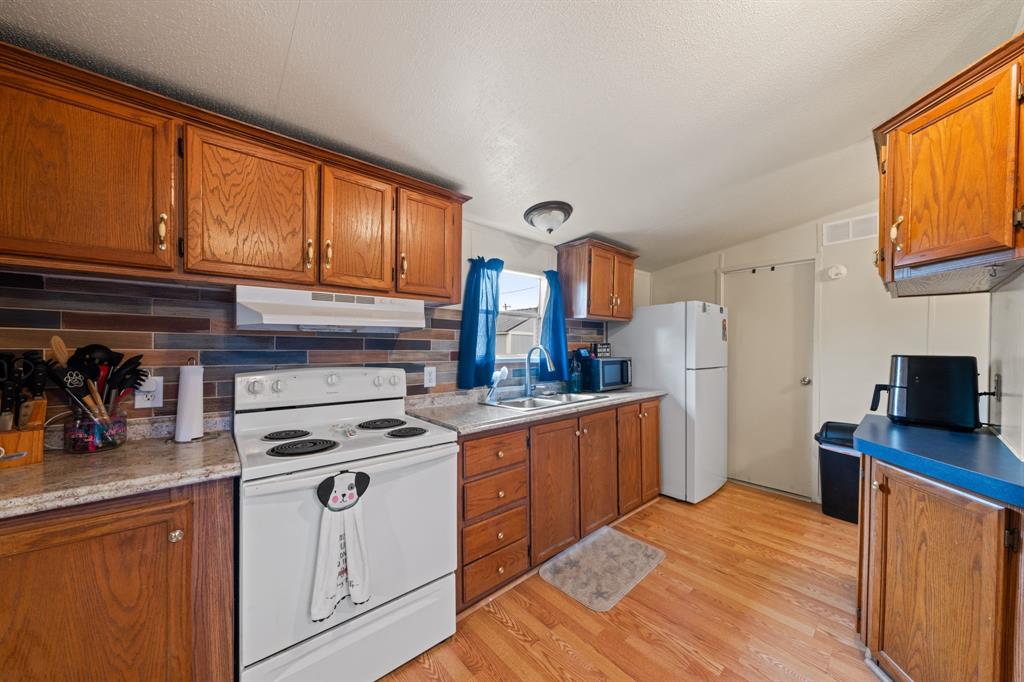 1304 Rains County Road 1530 Point, TX 75472 - Photo 11 of 40 a kitchen with stainless steel appliances granite countertop a stove a sink dishwasher and a refrigerator