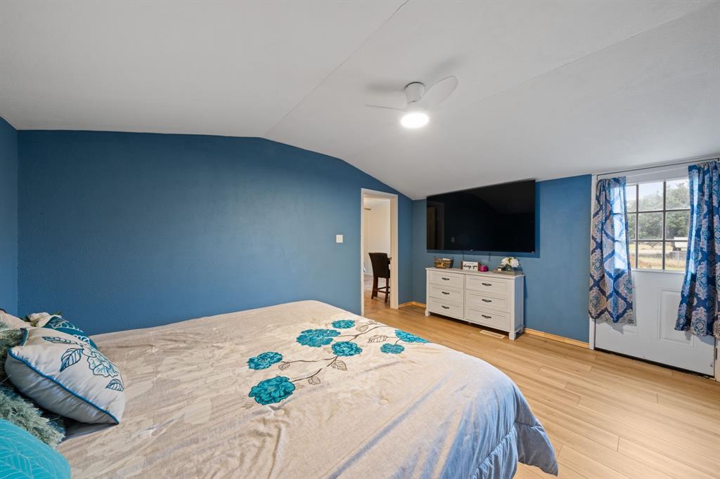 1304 Rains County Road 1530 Point, TX 75472 - Photo 14 of 40 a bedroom with a bed and a flat screen tv