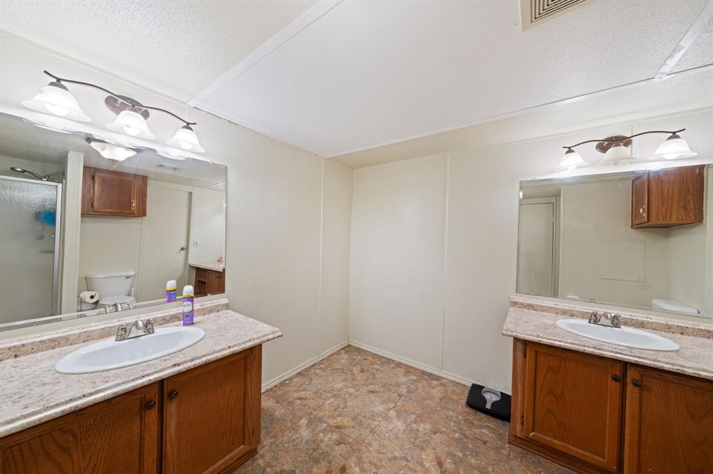1304 Rains County Road 1530 Point, TX 75472 - Photo 19 of 40 a bathroom with a sink and a mirror