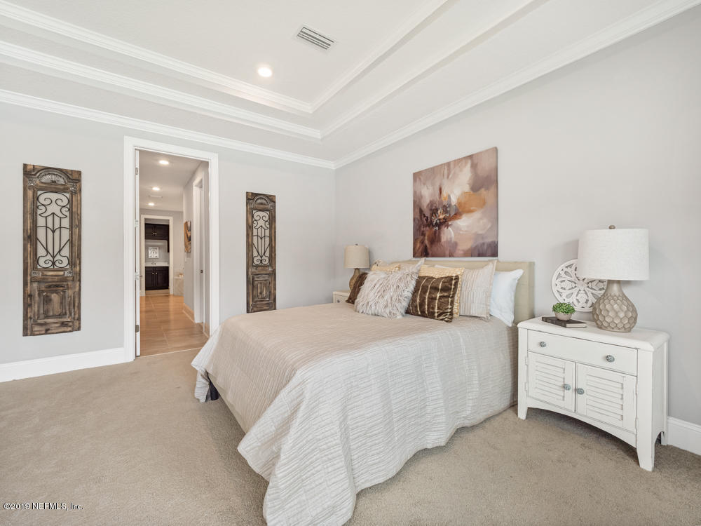 743 Cross Ridge Drive Ponte Vedra, FL 32081 - Photo 36 of 83 a spacious bedroom with a bed and a lamp on dresser