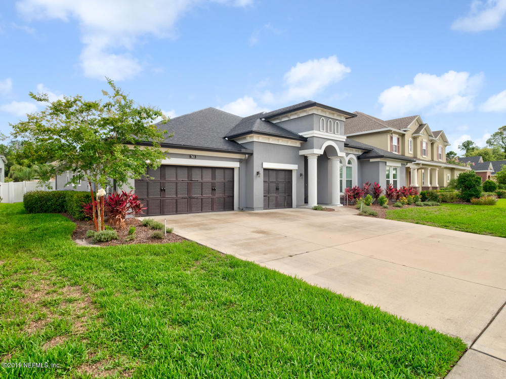 743 Cross Ridge Drive Ponte Vedra, FL 32081 - Photo 4 of 83 a view of a white house with a small yard and a large tree