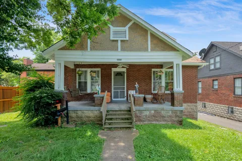 a view of a house with a backyard and sitting area