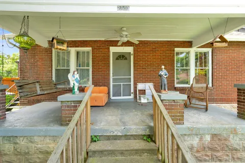 a view of a patio with couches chairs and potted plants