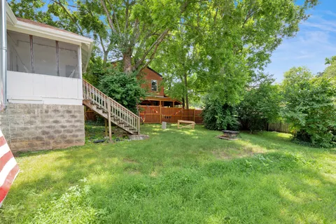 a view of a house with a backyard