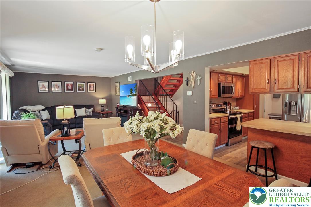 3470 Brodhead Road Bethlehem, PA 18020 - Photo 40 of 84 Natural light illuminates this versatile space, seamlessly connecting the dining area, living room, and kitchen for fluid living.