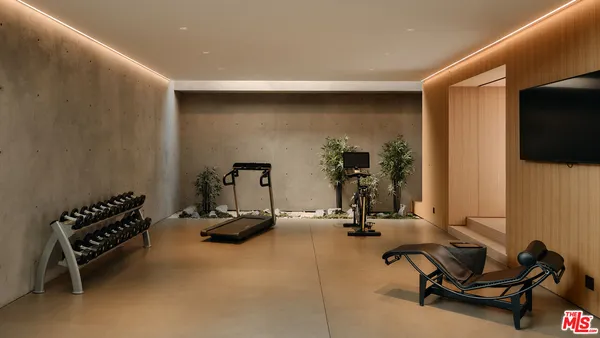 a room with gym equipment and a flat screen tv