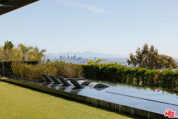a view of swimming pool with a garden and seating area