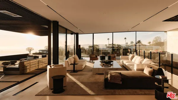 a living room with patio furniture and a floor to ceiling window