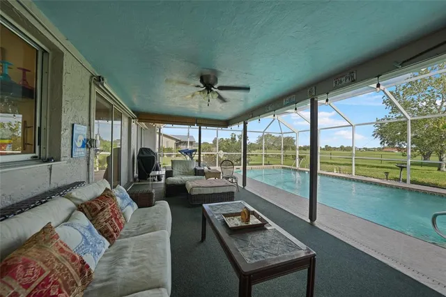 a living room with furniture and a floor to ceiling window