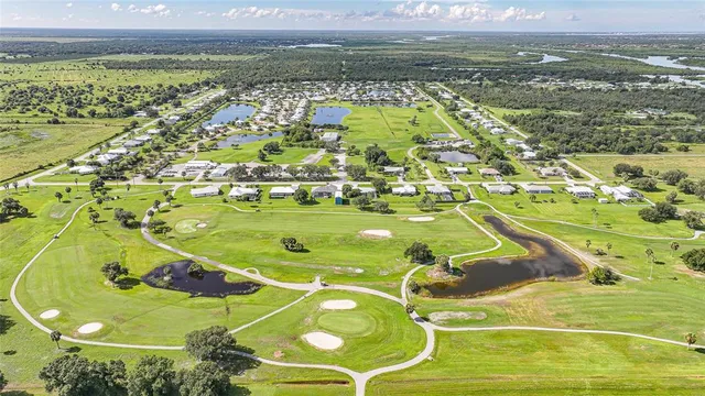 an aerial view of a house with a garden and lake view