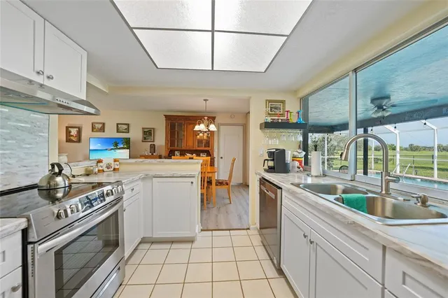 a kitchen with sink and cabinets
