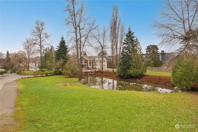 a view of yard with swimming pool and trees