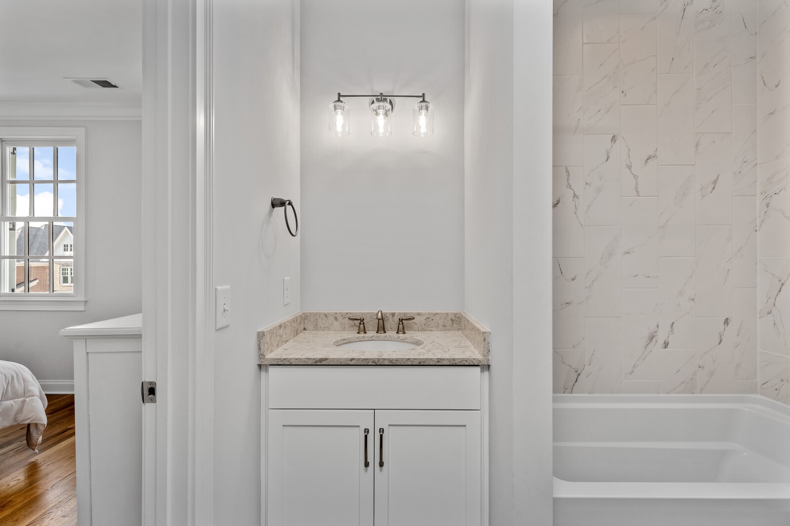 844 Horizon Drive Franklin, TN 37064 - Photo 33 of 48 a bathroom with a granite countertop sink a mirror and a bathtub