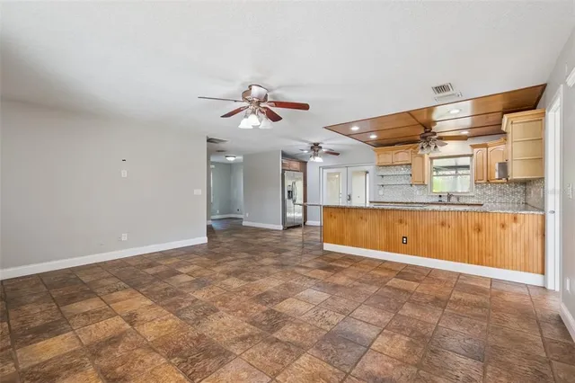 a view of a kitchen with a sink and a chandelier fan