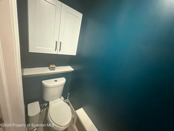 a white toilet sitting next to a bathroom sink