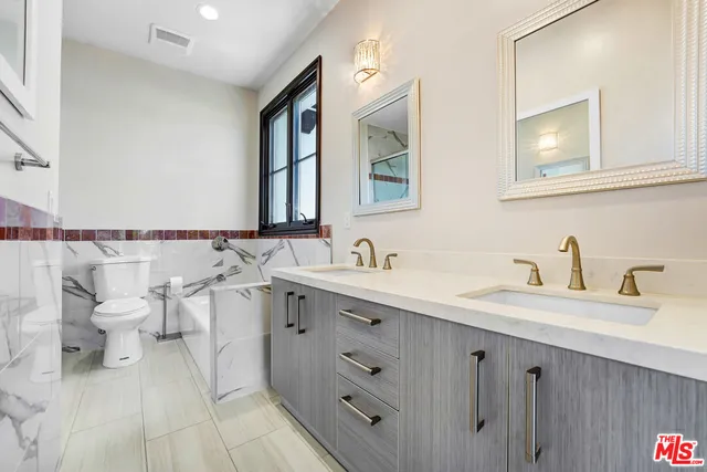 a spacious bathroom with a double vanity sink mirror and
