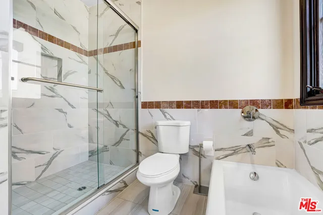 a white toilet sitting next to a bathroom sink