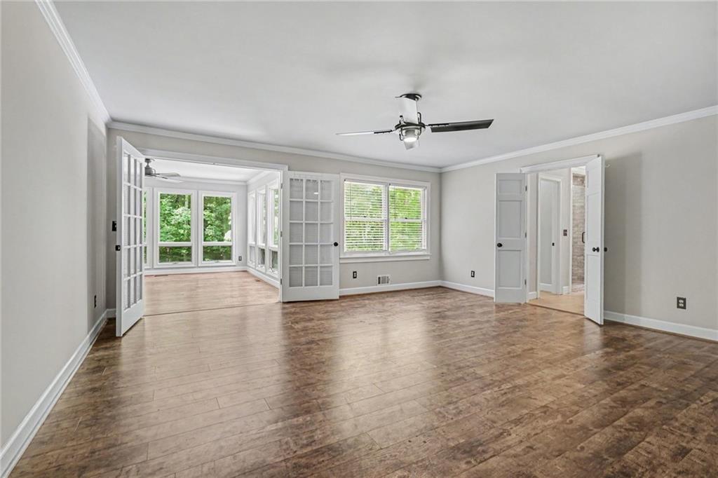 3597 Smithtown Road Suwanee, GA 30024 - Photo 3 of 24 a view of empty room with wooden floor and fan