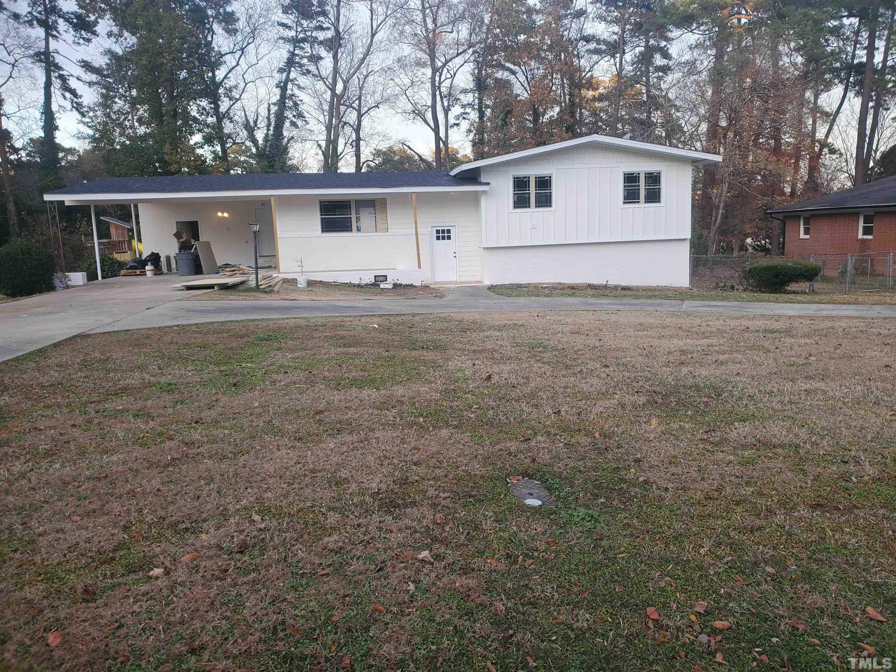 319 Golf Course Drive Raleigh, NC 27610 - Photo 1 of 13 a view of a yard in front of a house with large trees