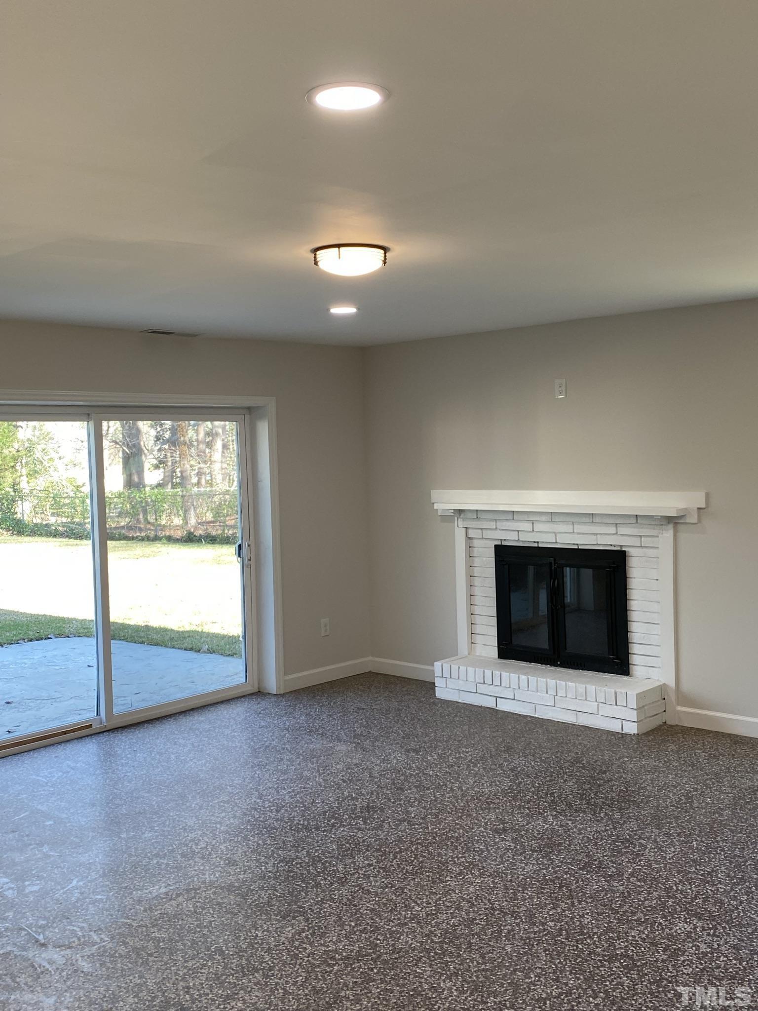 319 Golf Course Drive Raleigh, NC 27610 - Photo 7 of 13 a view of an empty room with a fireplace and a fireplace