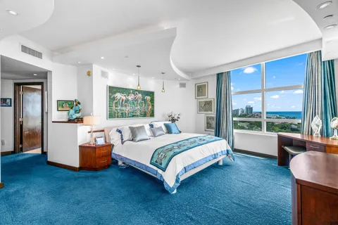 a spacious bedroom with a large bed and a window