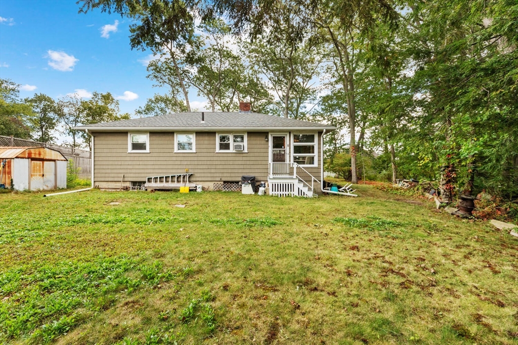 8 Everett Street Wakefield, MA 01880 - Photo 29 of 32 a backyard of a house with garden and outdoor seating