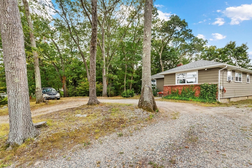 8 Everett Street Wakefield, MA 01880 - Photo 5 of 32 a house with trees in front of it