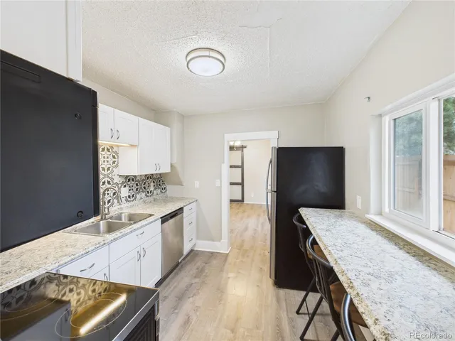 a kitchen with a stove and a white cabinets