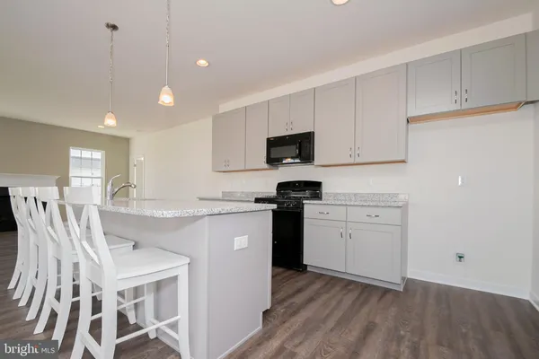 a kitchen with a sink window and stainless steel appliances