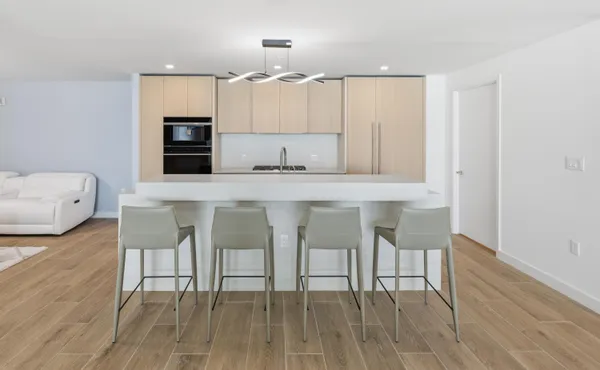 a large kitchen with lots of counter top space and stainless steel appliances