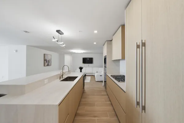 a kitchen with kitchen island a counter top space a stove and cabinets