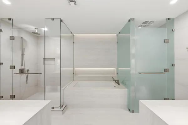 a bathroom with a tub shower vanity and sink