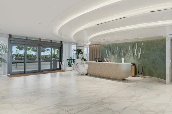 a lobby with furniture and floor to ceiling window