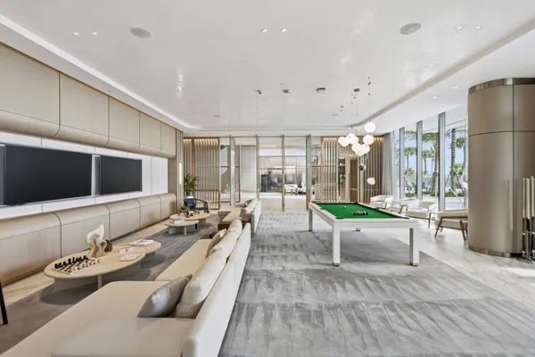 a living room filled with furniture and a potted plant